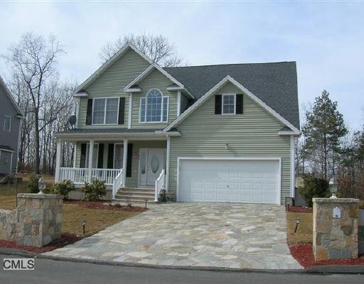 a front view of a house with garage