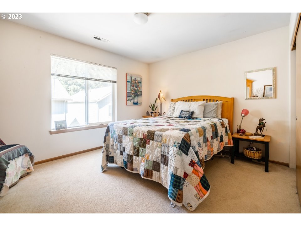 15469 Southwest Bygones Court Beaverton, OR 97007 - Photo 13 of 32 a bedroom with bed and a window