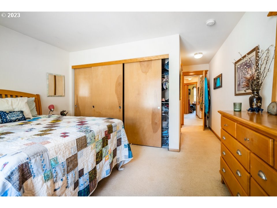 15469 Southwest Bygones Court Beaverton, OR 97007 - Photo 14 of 32 a bedroom with a bed and a flat tv screen on dresser