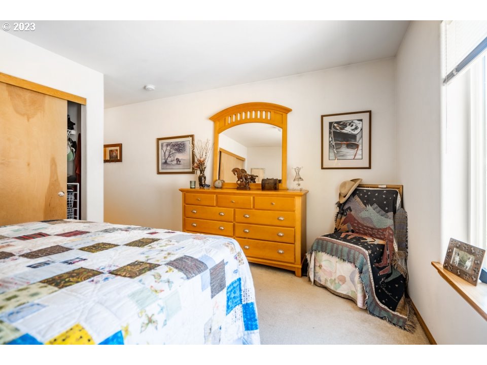 15469 Southwest Bygones Court Beaverton, OR 97007 - Photo 15 of 32 a bedroom with a bed and a dresser