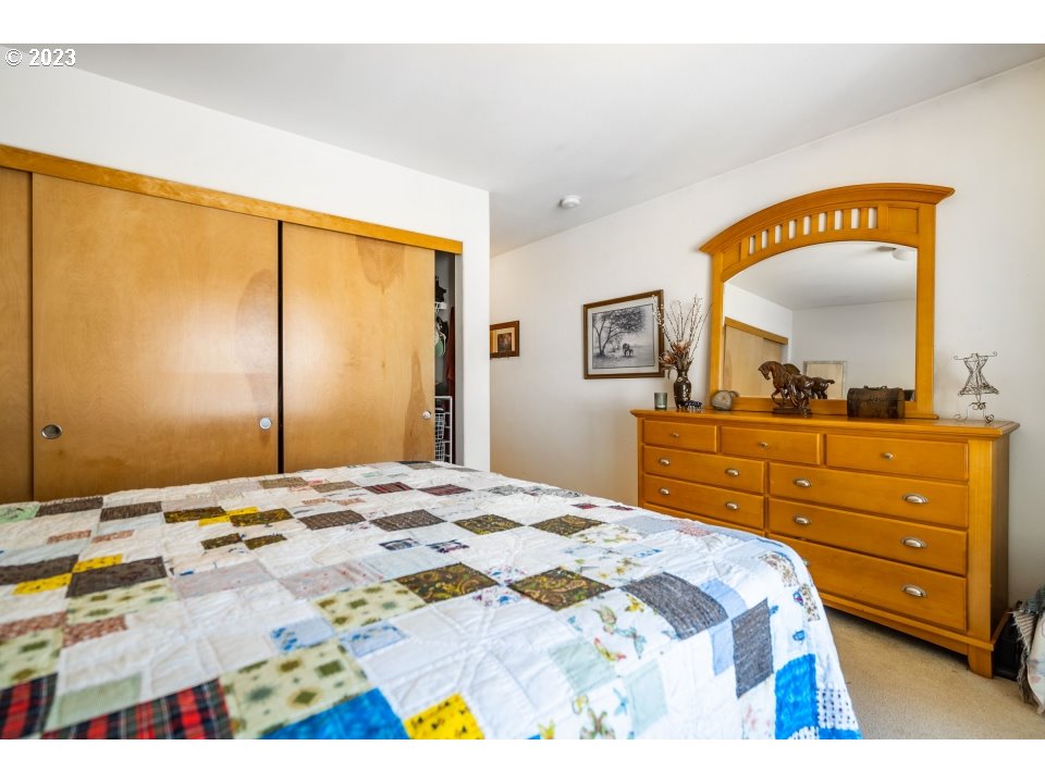 15469 Southwest Bygones Court Beaverton, OR 97007 - Photo 16 of 32 a bedroom with a bed and a mirror