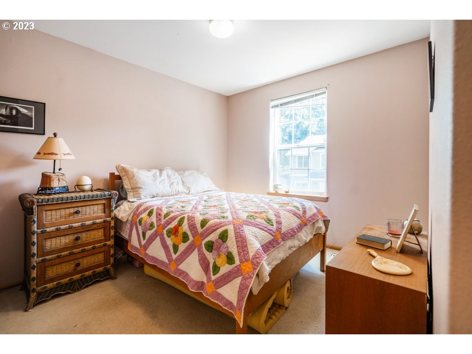15469 Southwest Bygones Court Beaverton, OR 97007 - Photo 18 of 32 a bedroom with a bed and a window