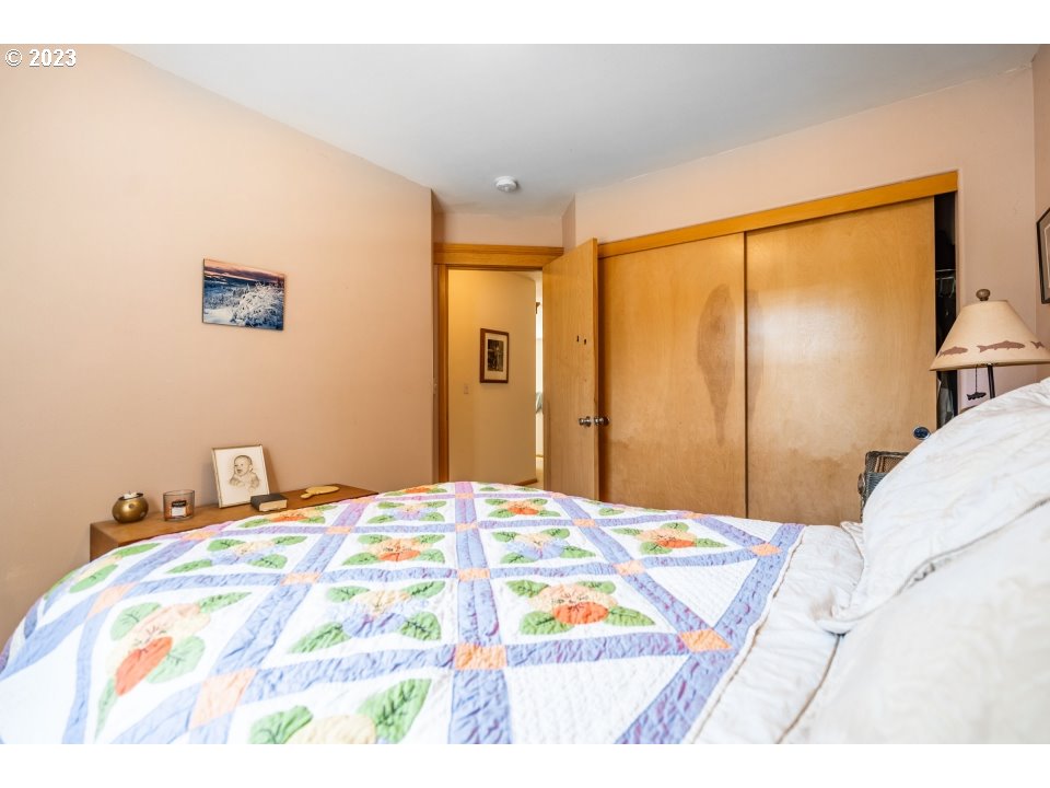 15469 Southwest Bygones Court Beaverton, OR 97007 - Photo 19 of 32 a bedroom with a bed and a large mirror