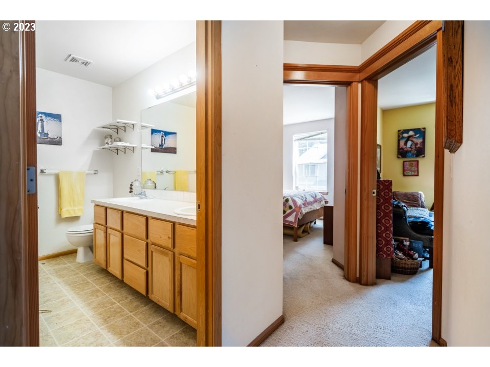 15469 Southwest Bygones Court Beaverton, OR 97007 - Photo 21 of 32 a en suite bathroom with a double vanity sink and a mirror
