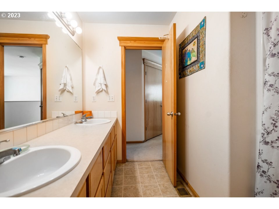 15469 Southwest Bygones Court Beaverton, OR 97007 - Photo 25 of 32 a bathroom with a sink and a mirror
