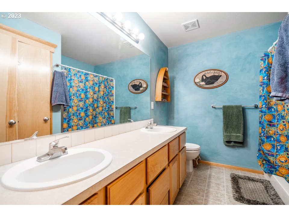15469 Southwest Bygones Court Beaverton, OR 97007 - Photo 28 of 32 a bathroom with a sink a vanity and a mirror