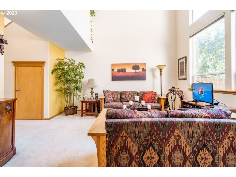 15469 Southwest Bygones Court Beaverton, OR 97007 - Photo 4 of 32 a living room with furniture and a large window