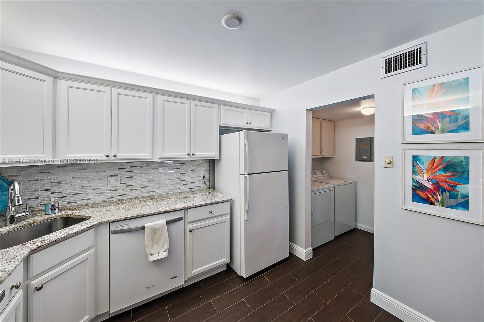 301 Pine Ridge Circle, Unit D2 Greenacres, FL 33463 - Photo 13 of 38 a kitchen with stainless steel appliances granite countertop a refrigerator and a sink