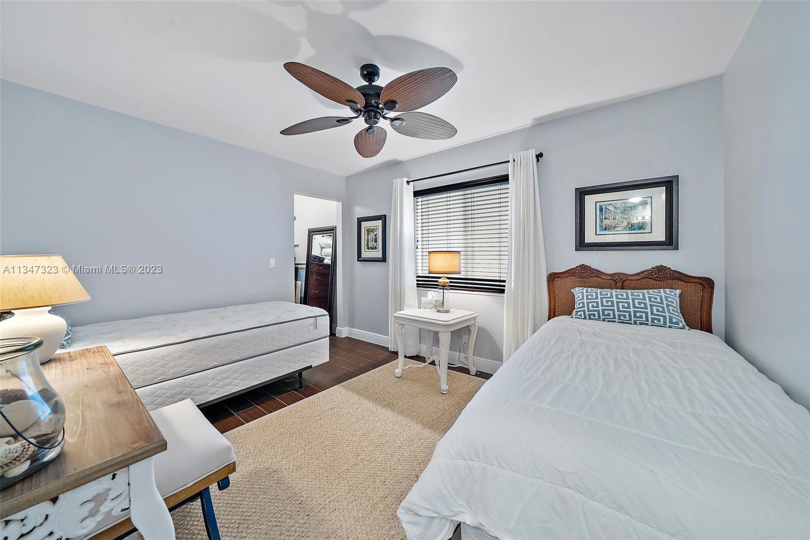 301 Pine Ridge Circle, Unit D2 Greenacres, FL 33463 - Photo 15 of 38 a bedroom with a bed and wooden floor