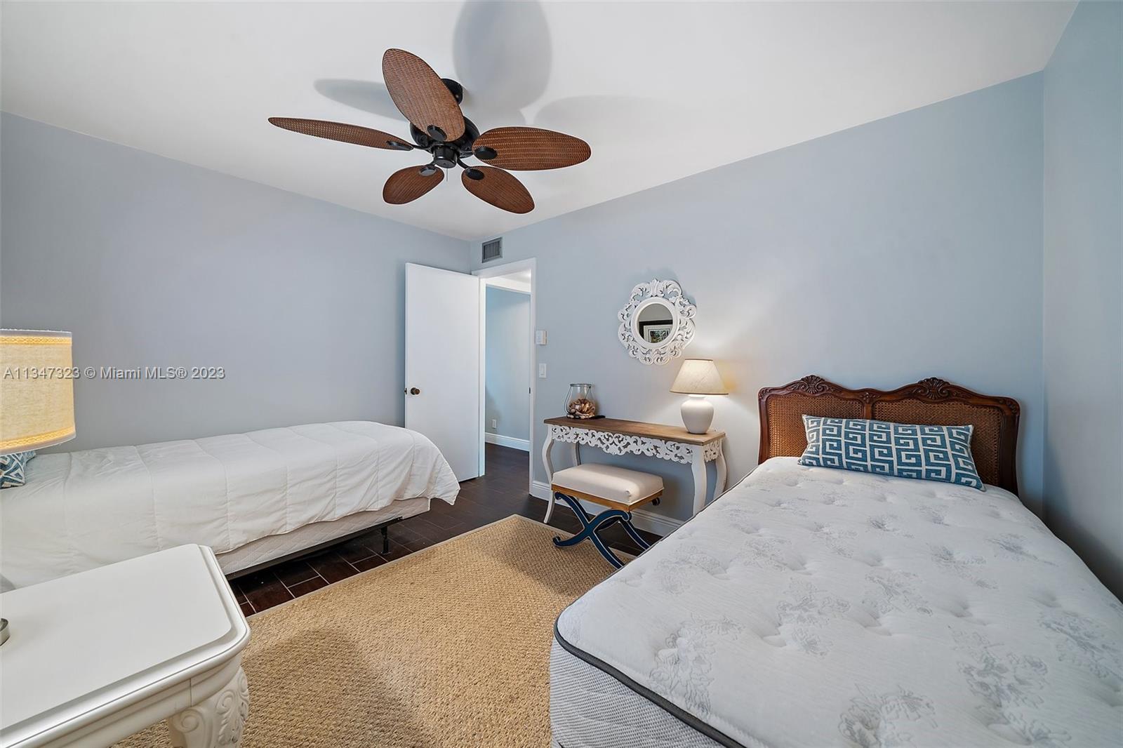 301 Pine Ridge Circle, Unit D2 Greenacres, FL 33463 - Photo 16 of 38 a bed room with two bed and a chandelier