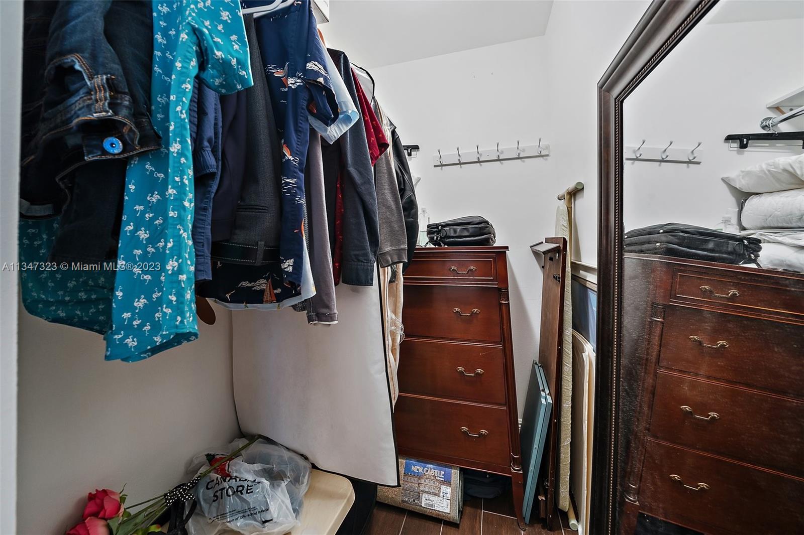 301 Pine Ridge Circle, Unit D2 Greenacres, FL 33463 - Photo 17 of 38 a view of walk in closet with clothes and shoes