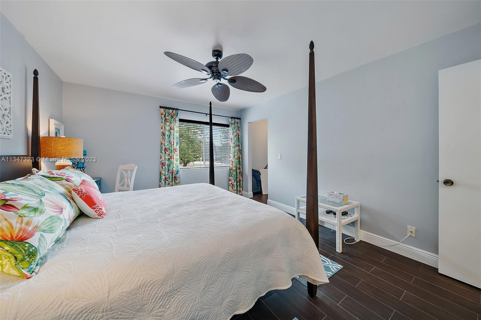 301 Pine Ridge Circle, Unit D2 Greenacres, FL 33463 - Photo 22 of 38 a bedroom with a bed and wooden floor