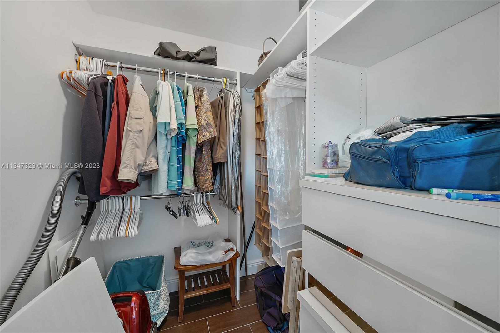 301 Pine Ridge Circle, Unit D2 Greenacres, FL 33463 - Photo 24 of 38 a view of walk in closet with clothes and shoes