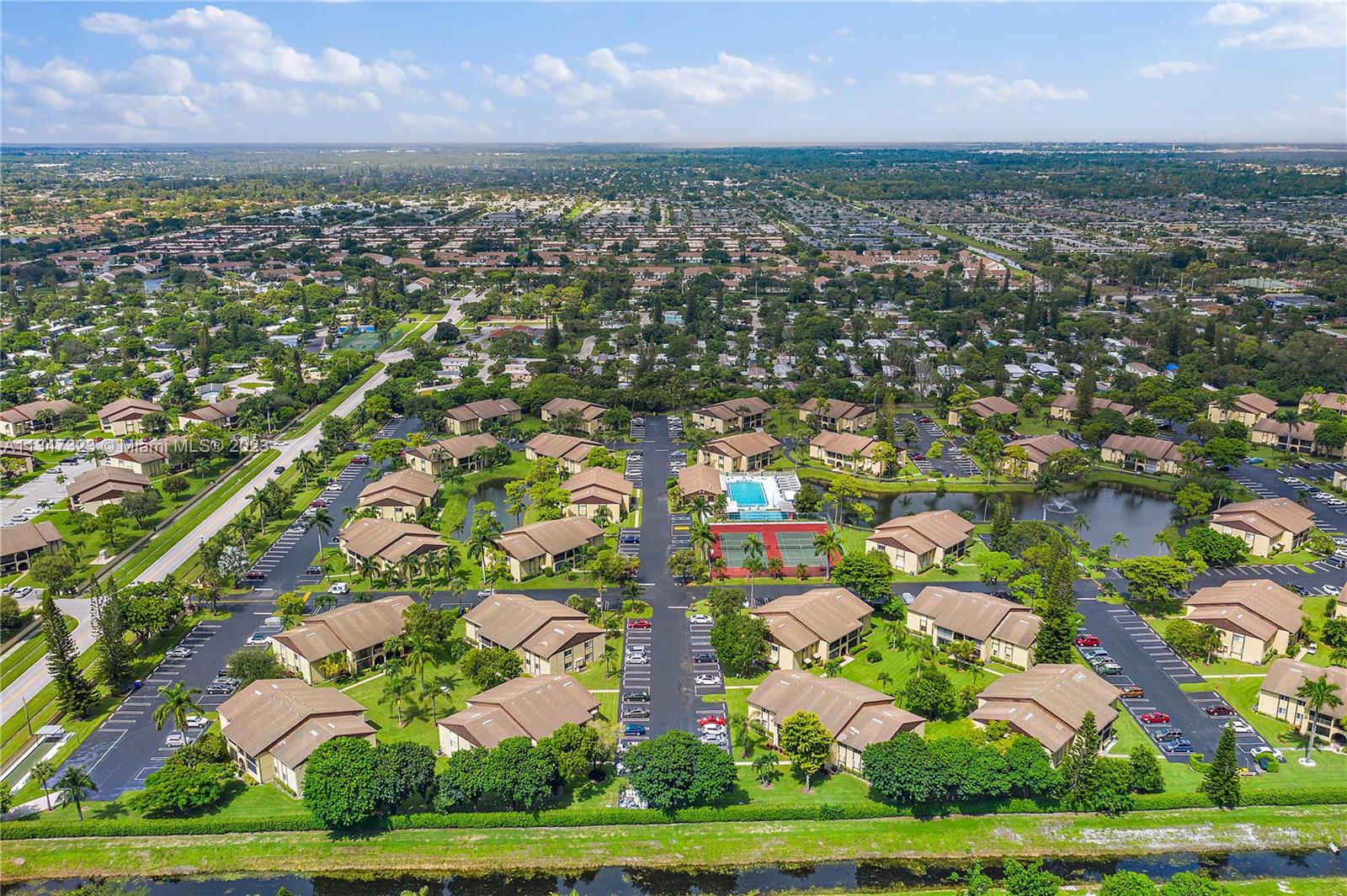 301 Pine Ridge Circle, Unit D2 Greenacres, FL 33463 - Photo 26 of 38 an aerial view of residential houses with outdoor space and trees