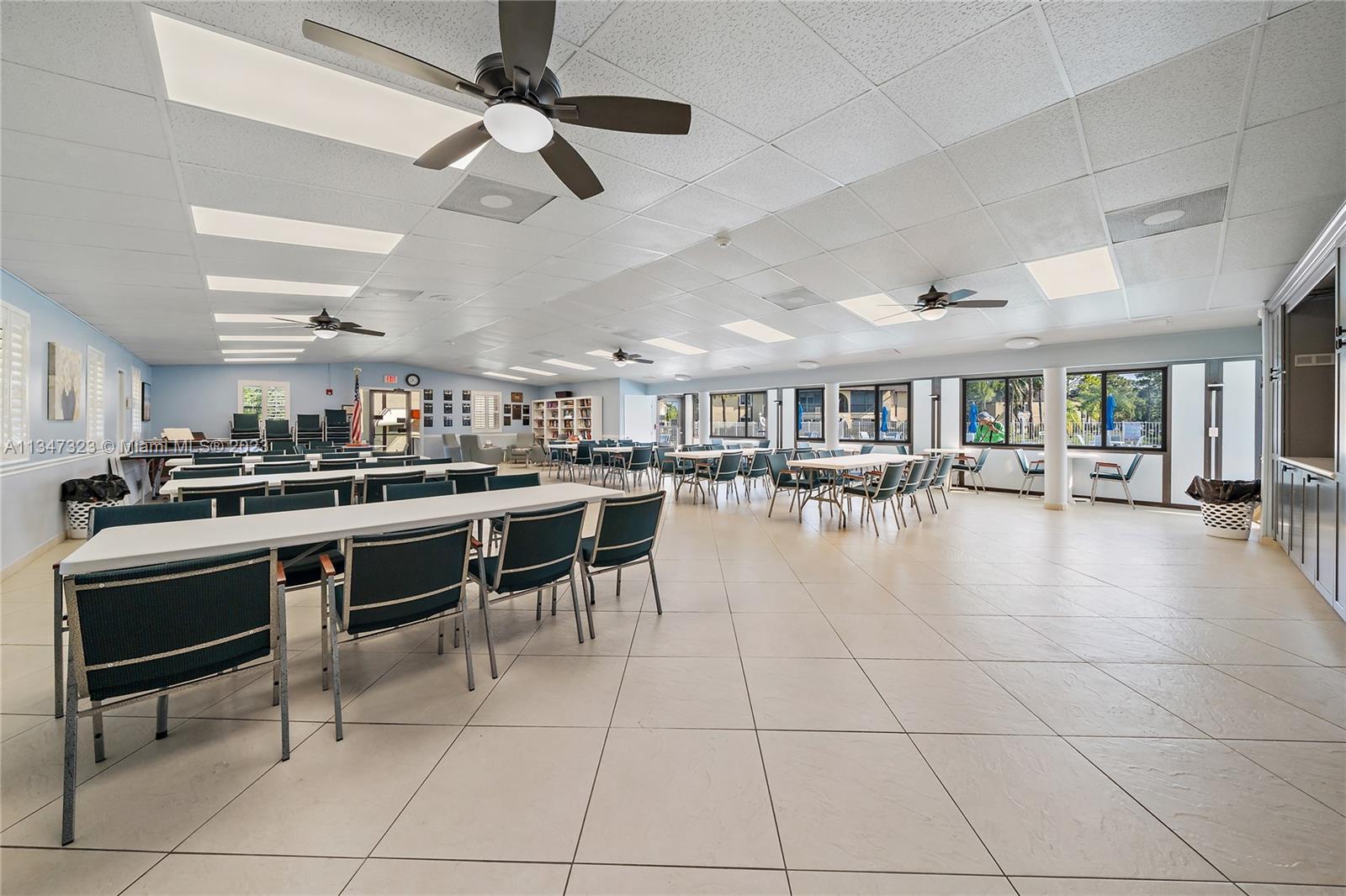 301 Pine Ridge Circle, Unit D2 Greenacres, FL 33463 - Photo 37 of 38 a room with lots of furniture and view of kitchen