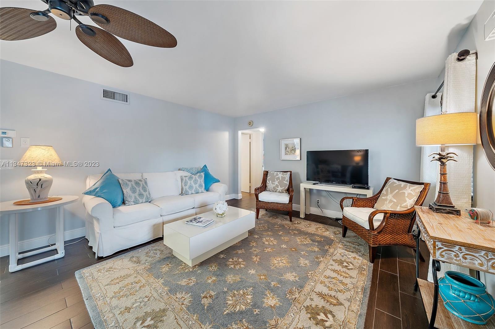 301 Pine Ridge Circle, Unit D2 Greenacres, FL 33463 - Photo 6 of 38 a living room with furniture and a flat screen tv