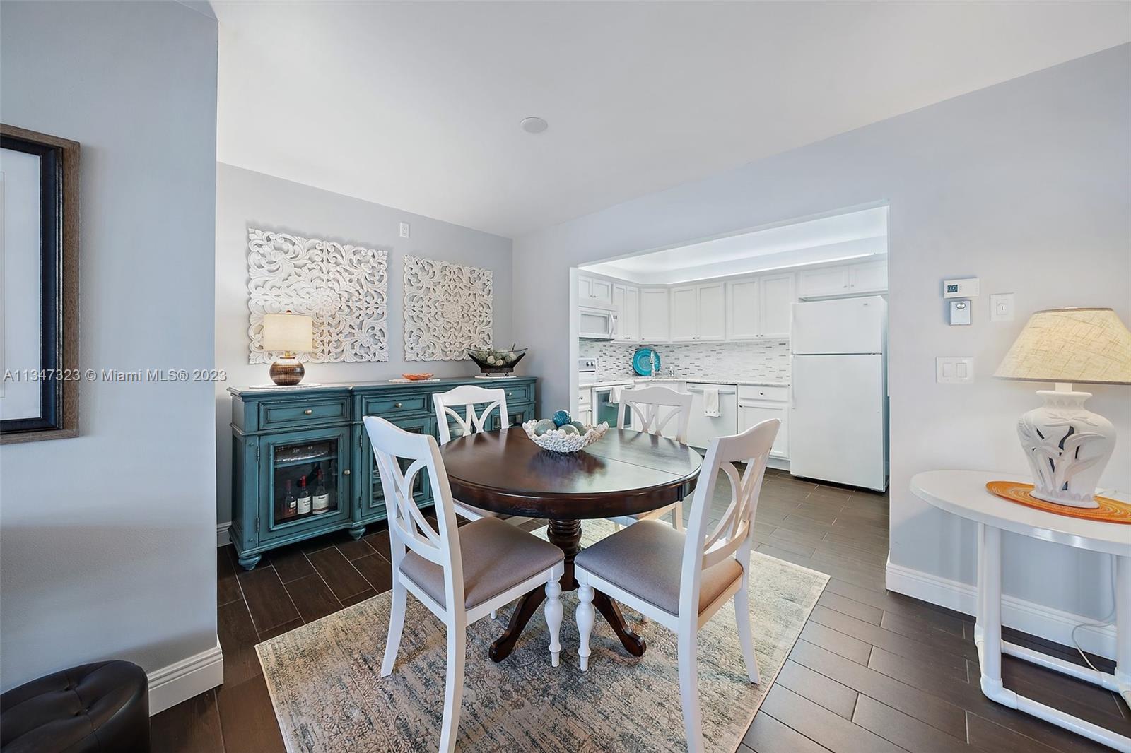 301 Pine Ridge Circle, Unit D2 Greenacres, FL 33463 - Photo 9 of 38 a view of a dining room with furniture and wooden floor