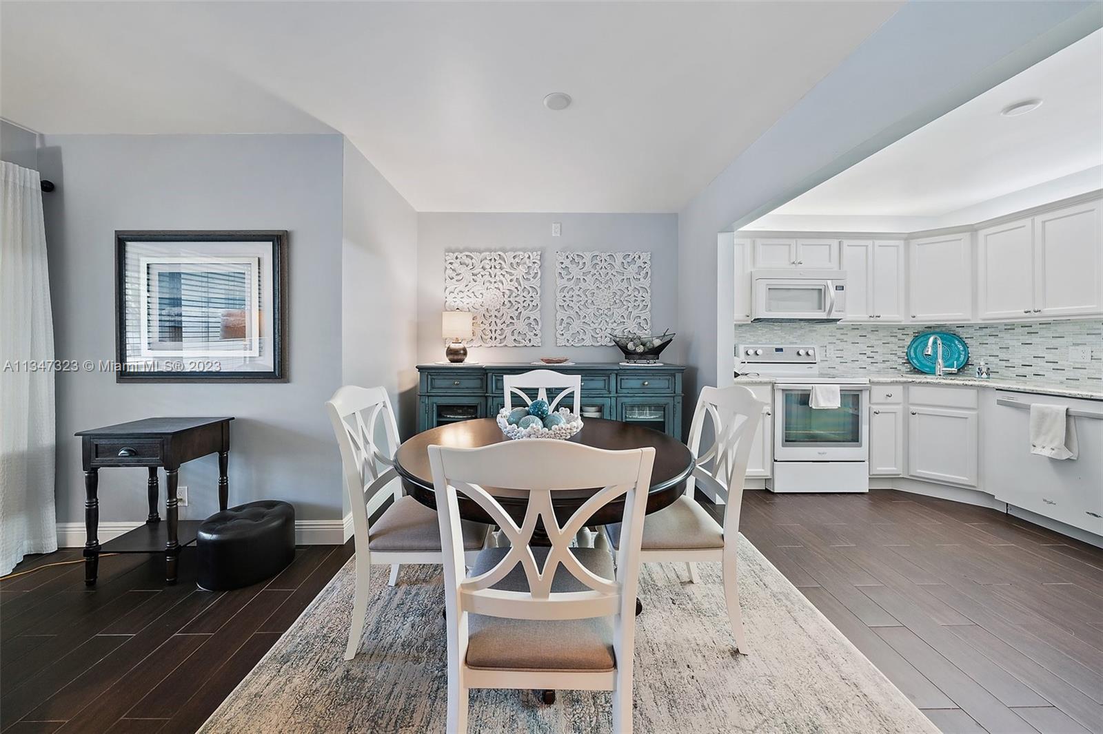 301 Pine Ridge Circle, Unit D2 Greenacres, FL 33463 - Photo 10 of 38 a view of a dining room with furniture and wooden floor