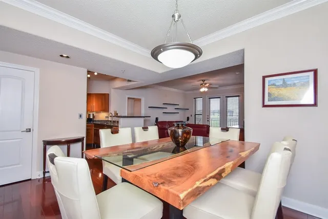 a living room with furniture a dining table and a chandelier