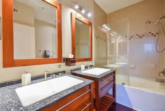 a bathroom with a tub sink and mirror