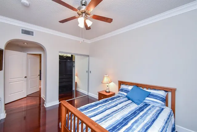 a bedroom with furniture and wooden floor
