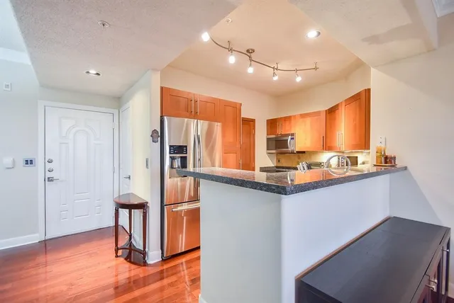 a kitchen with stainless steel appliances granite countertop a sink and stove top oven