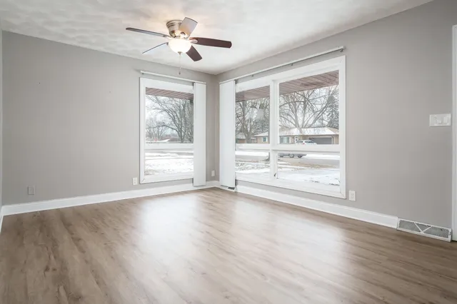 wooden floor in an empty room with a window