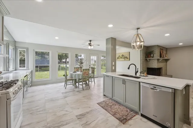a large white kitchen with lots of counter space and a sink