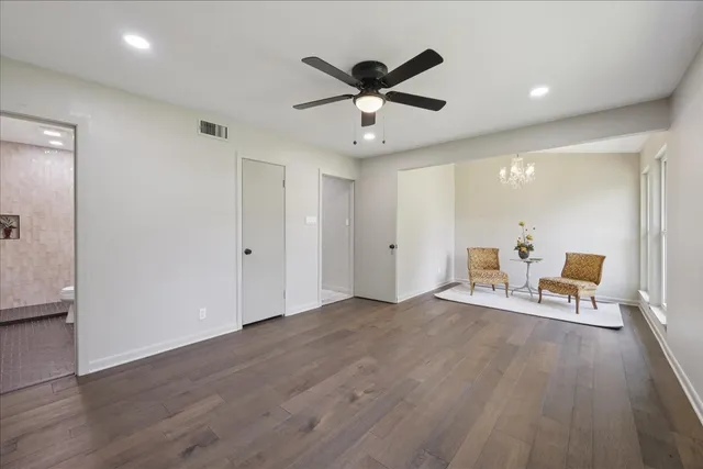 a view of a livingroom with workspace and a ceiling fan