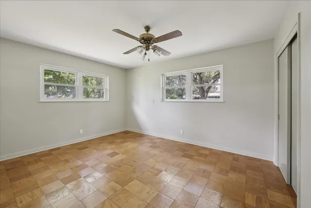 a view of room with window and ceiling fan