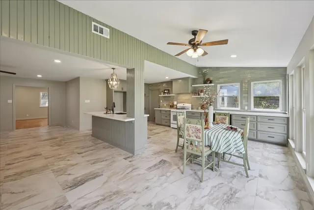 a large kitchen with a table and chairs in it