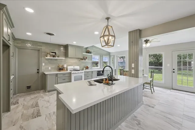 a kitchen with sink cabinets and window