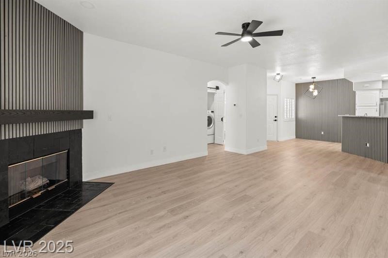 3320 South Fort Apache Road, Unit 125 Las Vegas, NV 89117 - Photo 4 of 26 A refined living area boasts a modern fireplace and durable plank flooring.