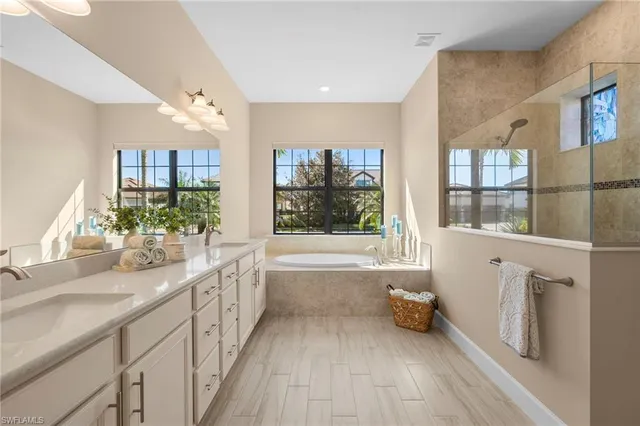 a large white kitchen with a large window