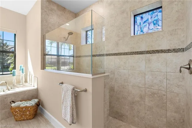a bathroom with a tub and a window