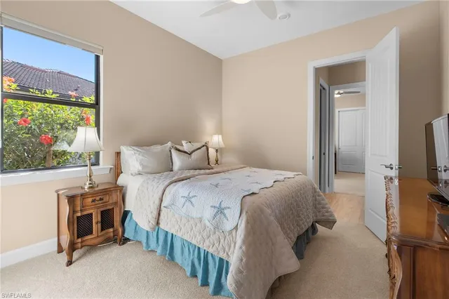 a bedroom with a bed and a flat tv screen on dresser