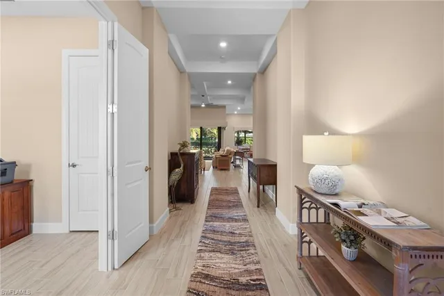 a hallway with furniture and a rug