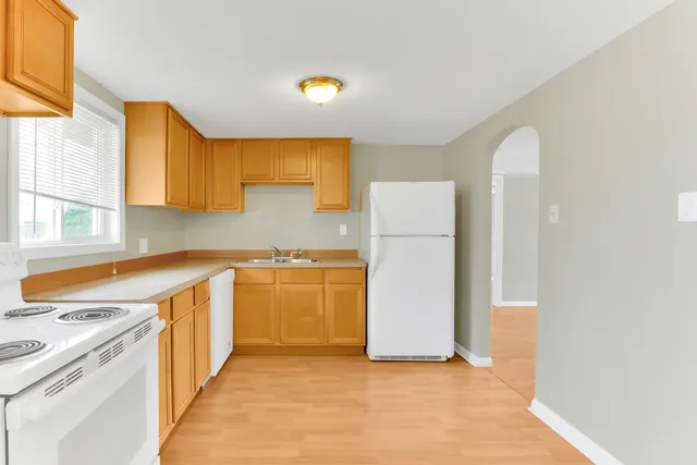 a kitchen with a refrigerator and a sink