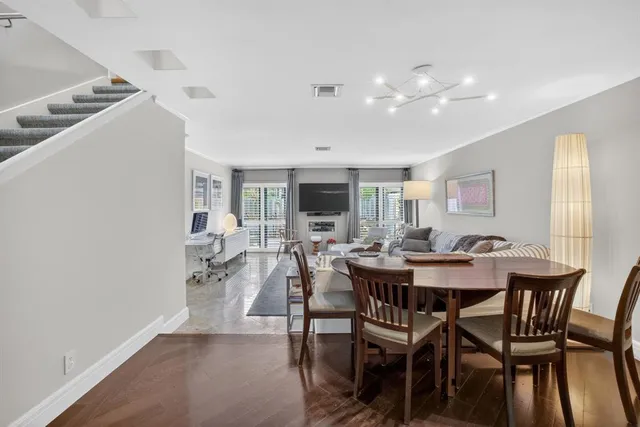 a kitchen with white cabinets and refrigerator