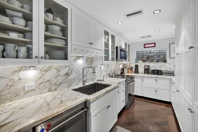 a spacious bathroom with a double vanity sink a mirror and a bathtub