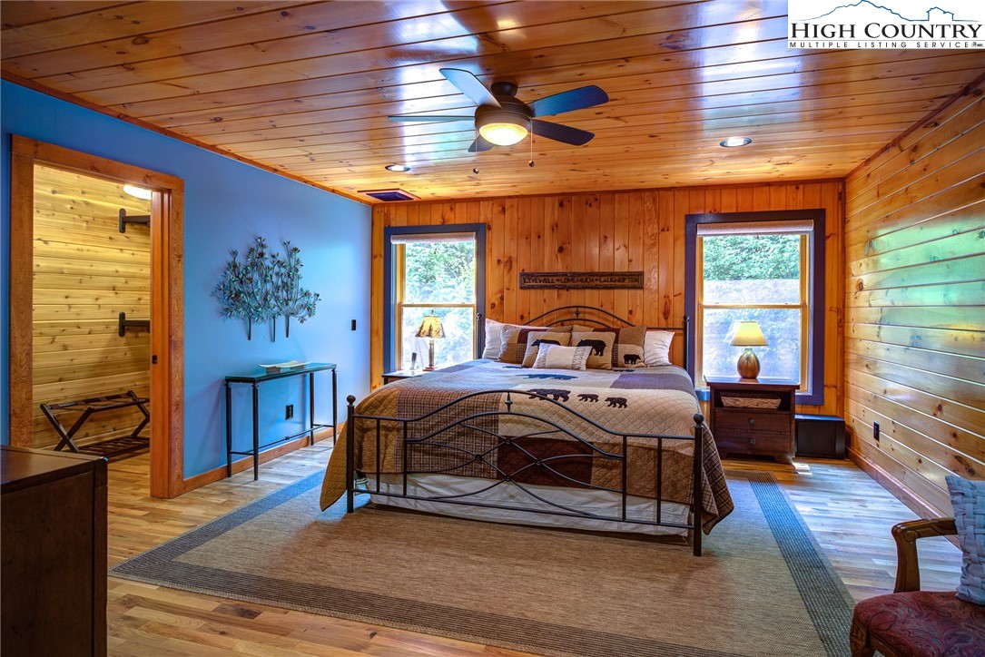 568 Auborn Trivette Road Sugar Grove, NC 28679 - Photo 13 of 29 a bedroom with a bed and wooden floor