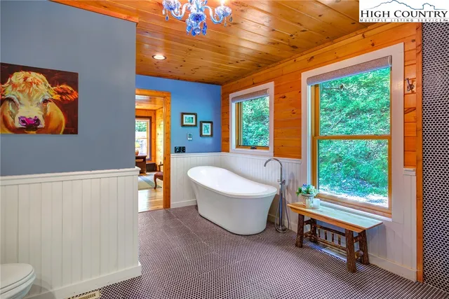 a room with furniture pool table and windows