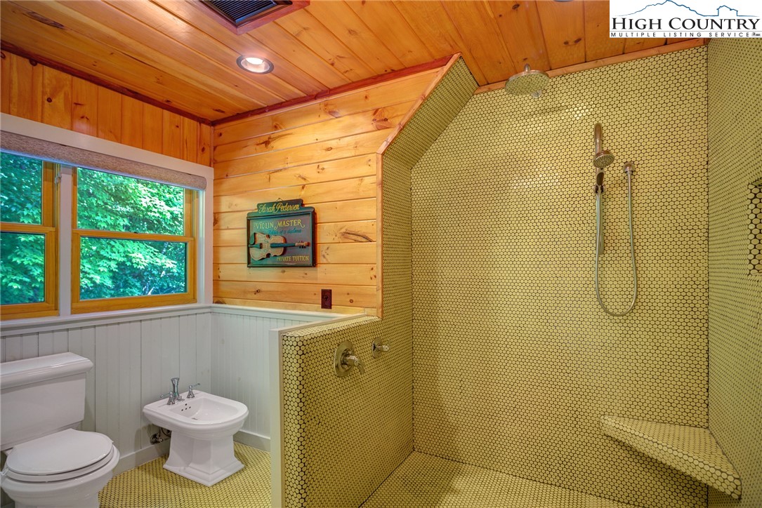 568 Auborn Trivette Road Sugar Grove, NC 28679 - Photo 21 of 29 a bathroom with a toilet sink and shower