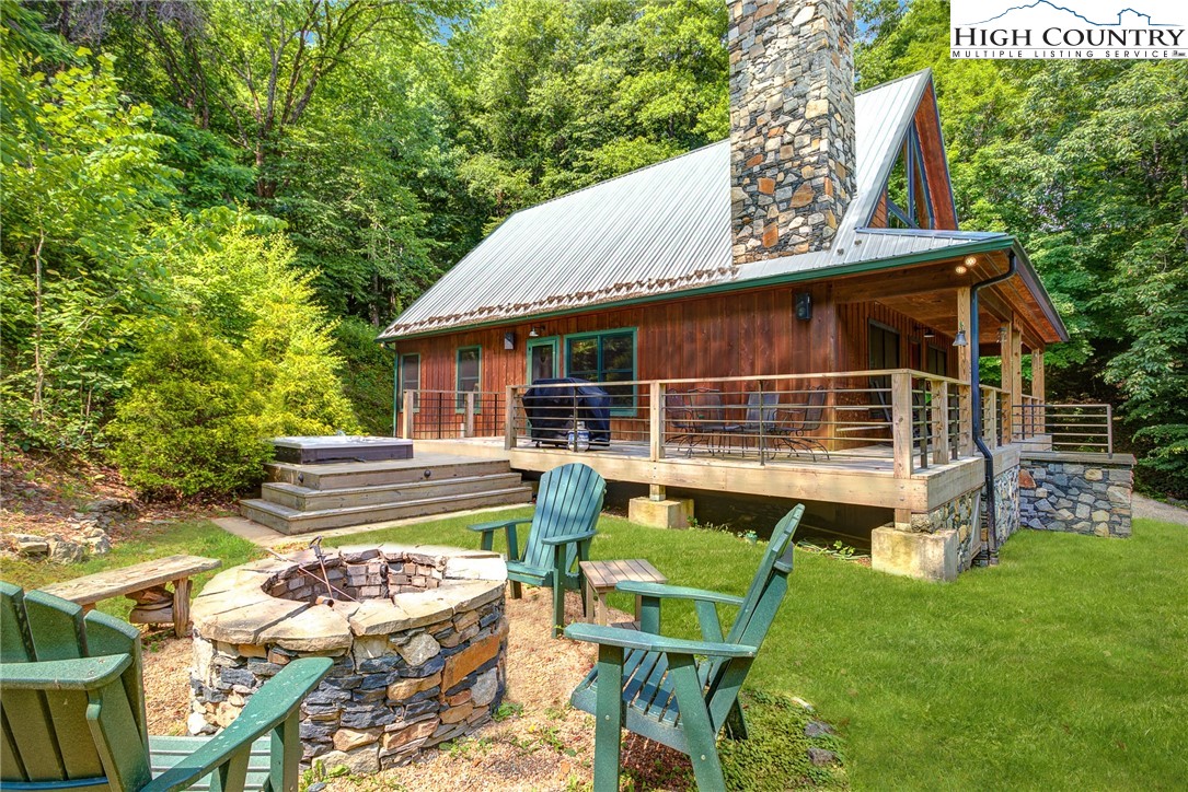 568 Auborn Trivette Road Sugar Grove, NC 28679 - Photo 23 of 29 a view of house with backyard outdoor seating and green space