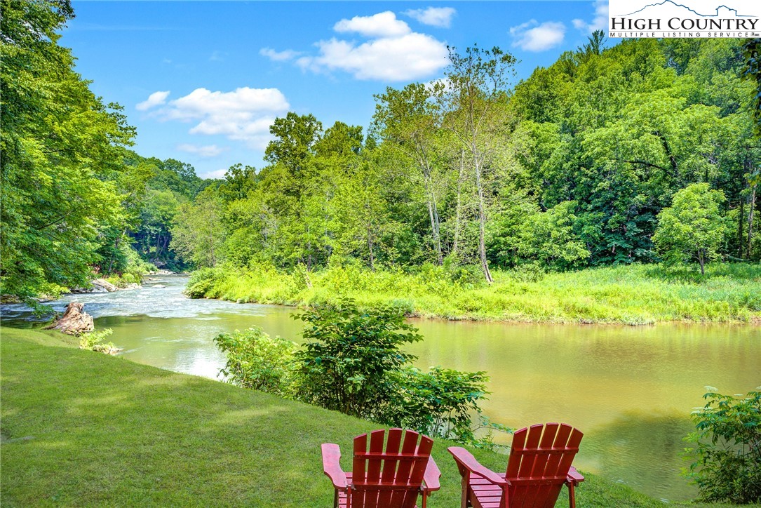 568 Auborn Trivette Road Sugar Grove, NC 28679 - Photo 26 of 29 a view of a lake with lawn chairs