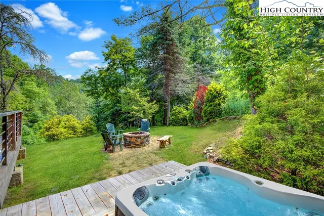 a backyard of a house with table and chairs