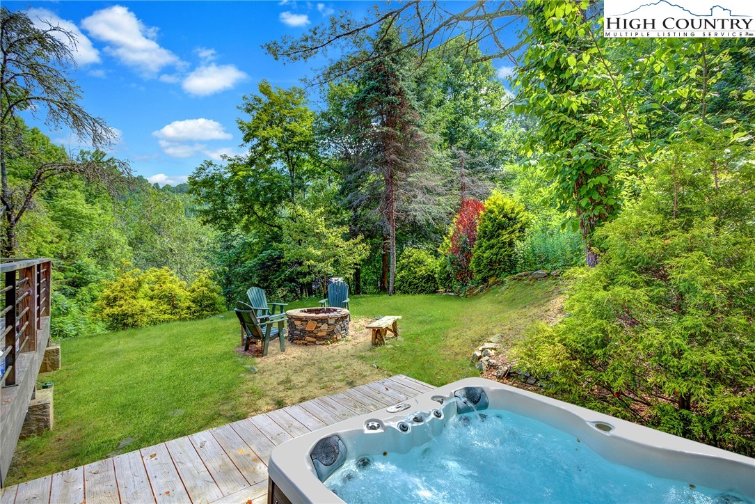 568 Auborn Trivette Road Sugar Grove, NC 28679 - Photo 6 of 29 a backyard of a house with table and chairs