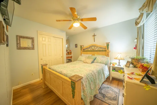 a bedroom with a bed and ceiling fan