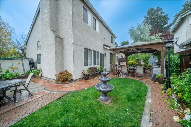 a view of patio with table and chairs and potted plants