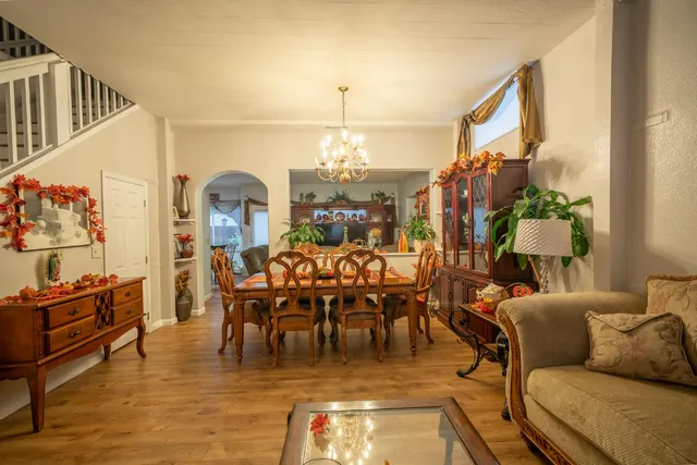 a living room with lots of furniture and a chandelier